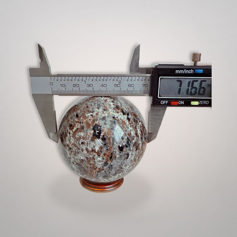 UV Sodalite 'Yooperlite' Sphere 464g measured at 71.66mm diameter with digital caliper, highlighting precise size for collectors.