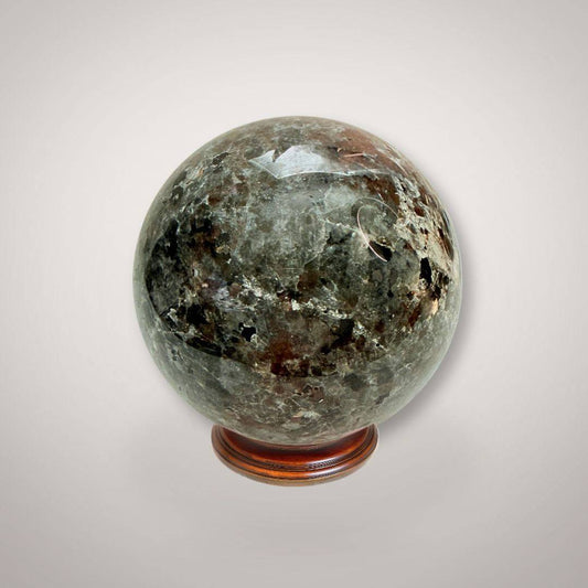 UV Sodalite (Yooperlite) Sphere 58mm with polished surface on wooden stand, showcasing natural mineral patterns for collectible display.