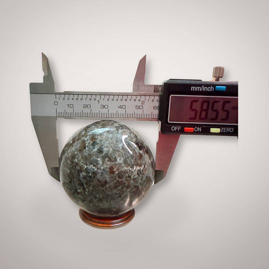 UV Sodalite (Yooperlite) Sphere 58mm measured with digital caliper, confirming precise size for mineral collectors and crystal enthusiasts.