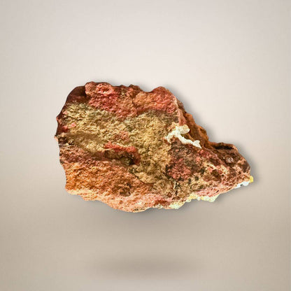 Underside of adamite with calcite on limonite showing natural iron-rich matrix and small yellow-green crystal areas along the edges.