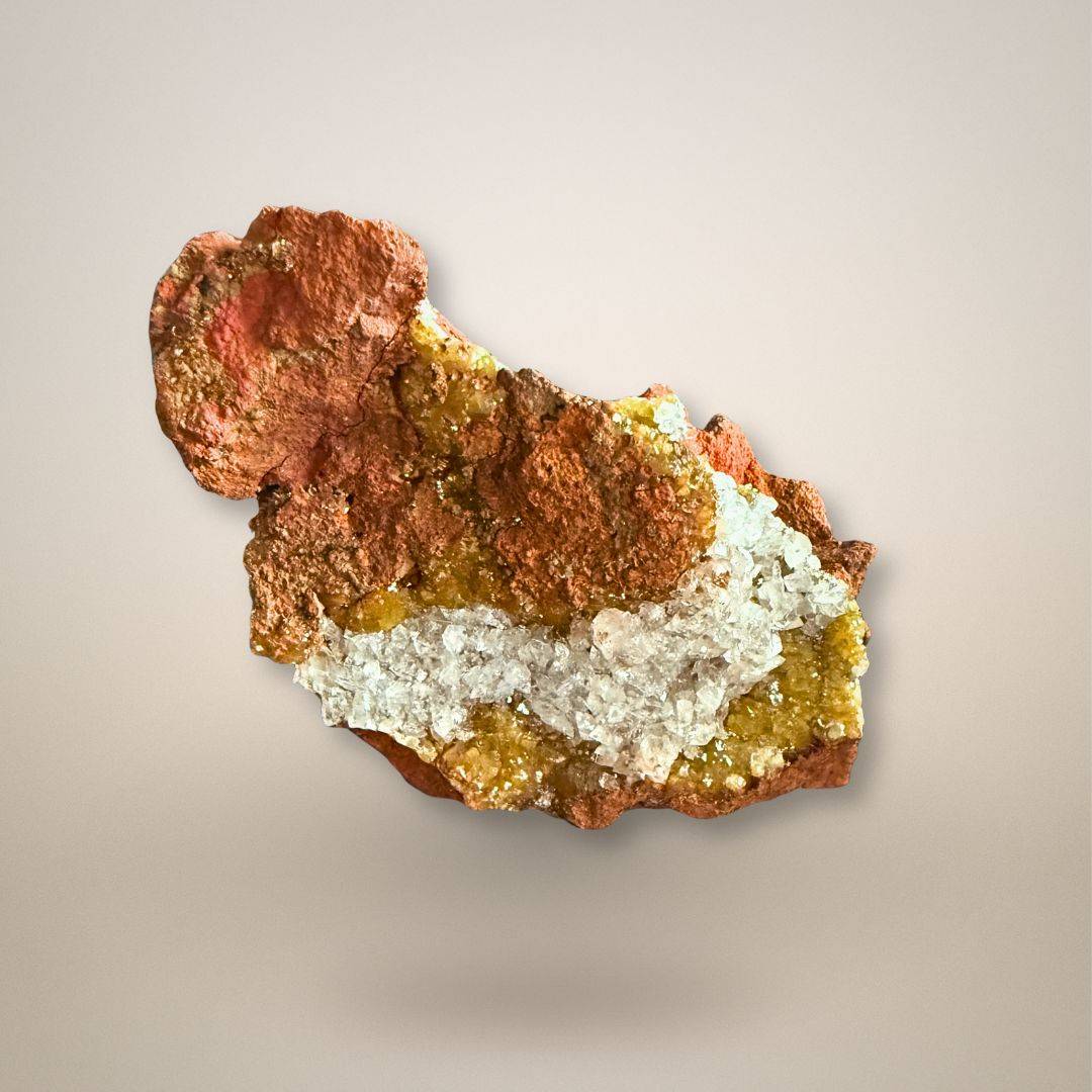Adamite with translucent calcite on rust-brown limonite from Ojuela Mine, Mexico, with honey-yellow and yellow-green mineral growth.