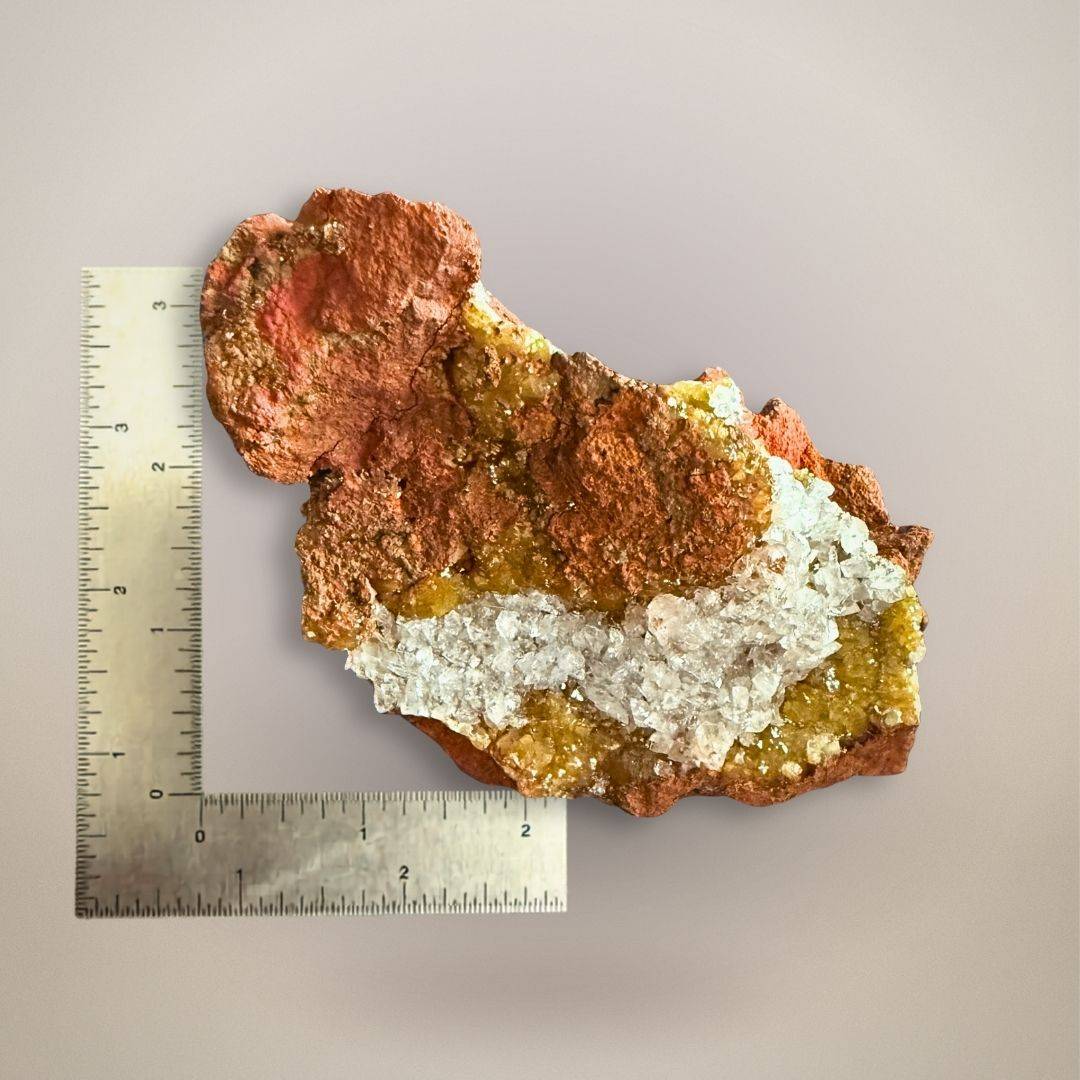 Ojuela Mine adamite and calcite specimen beside ruler for scale, showing the 4-inch small cabinet size and main crystal face.