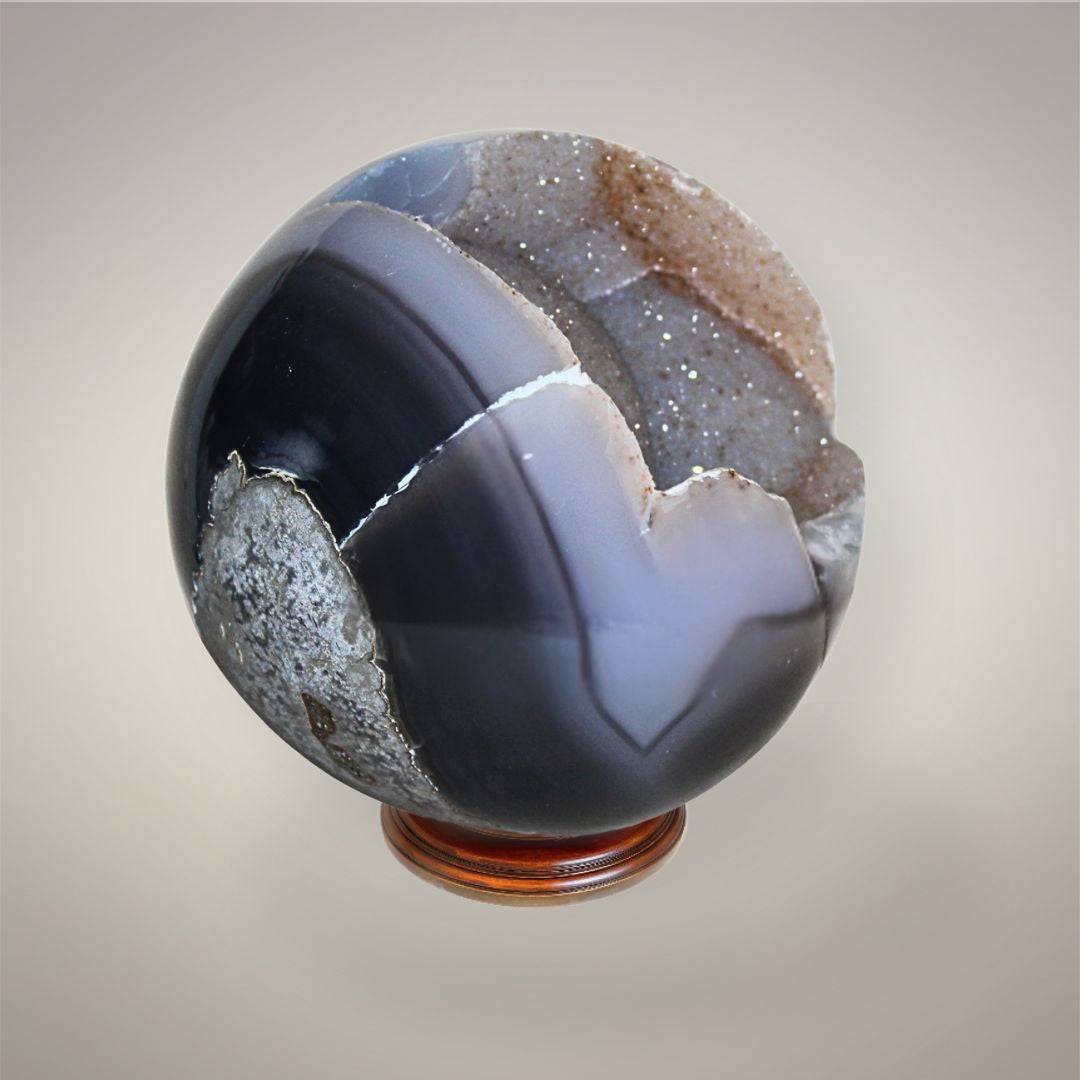 Brazilian Agate druzy sphere with smoky translucent banding, natural geode opening, exposed druzy quartz, and polished rounded form.
