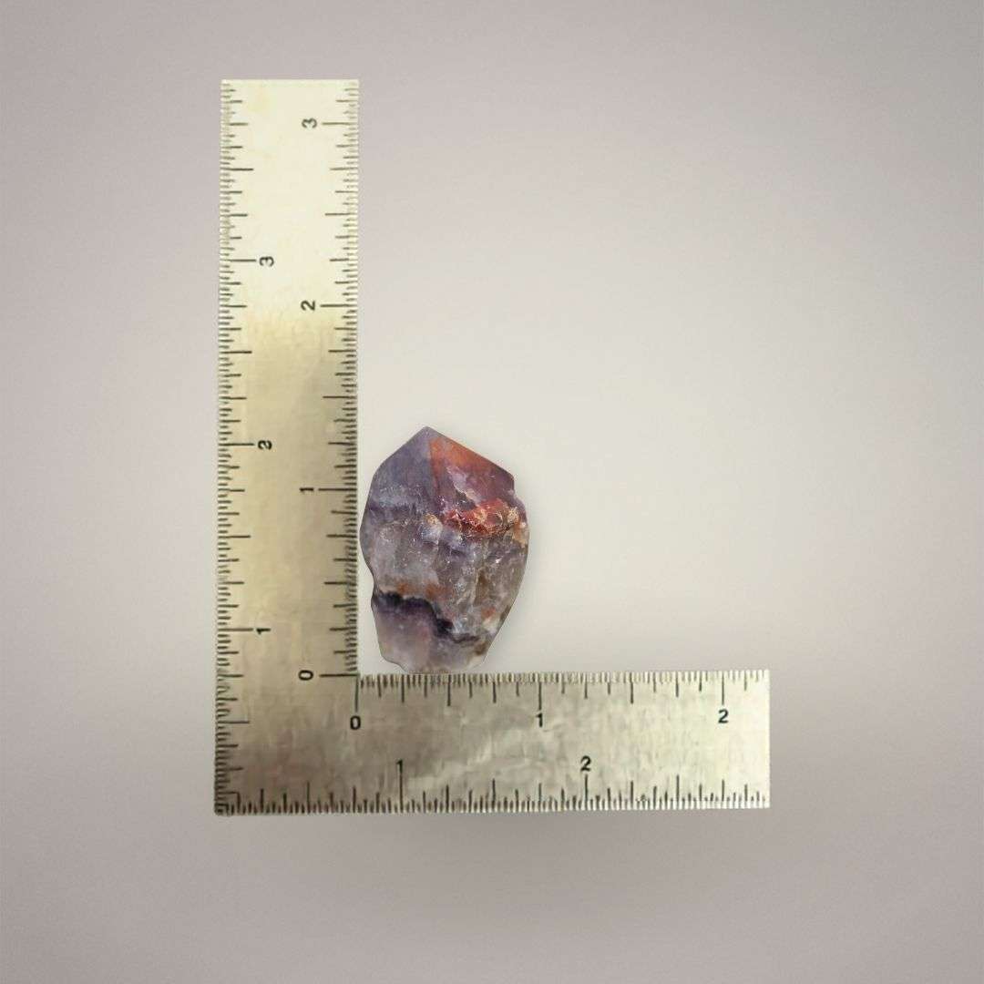 Natural Alien Amethyst point from India shown beside a ruler, measuring approximately 1 to 1.5 inches