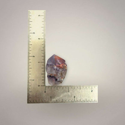 Natural Alien Amethyst point from India shown beside a ruler, measuring approximately 1 to 1.5 inches