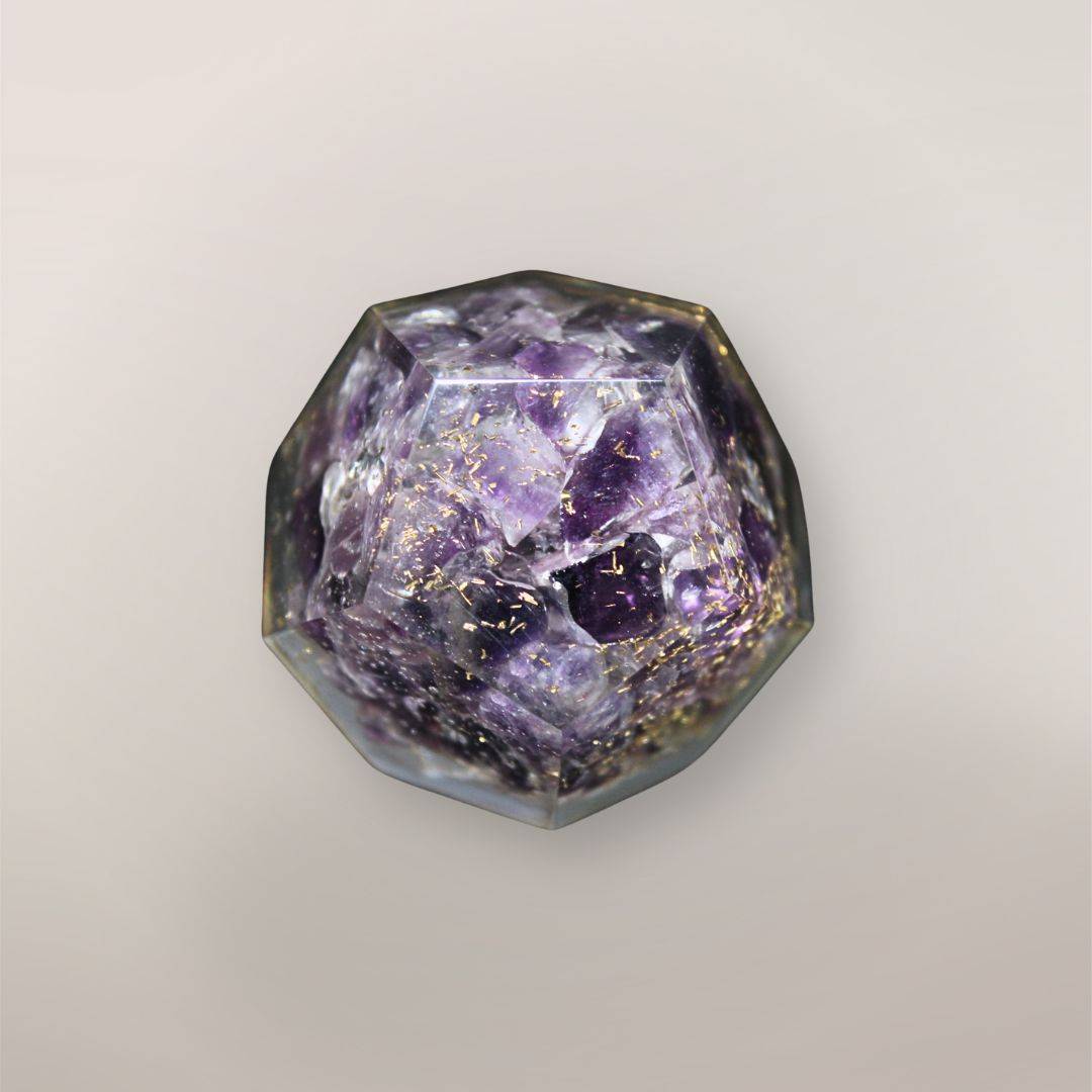 Back view of handmade Amethyst orgonite dodecahedron showing purple crystal chips, copper flakes, and faceted resin texture