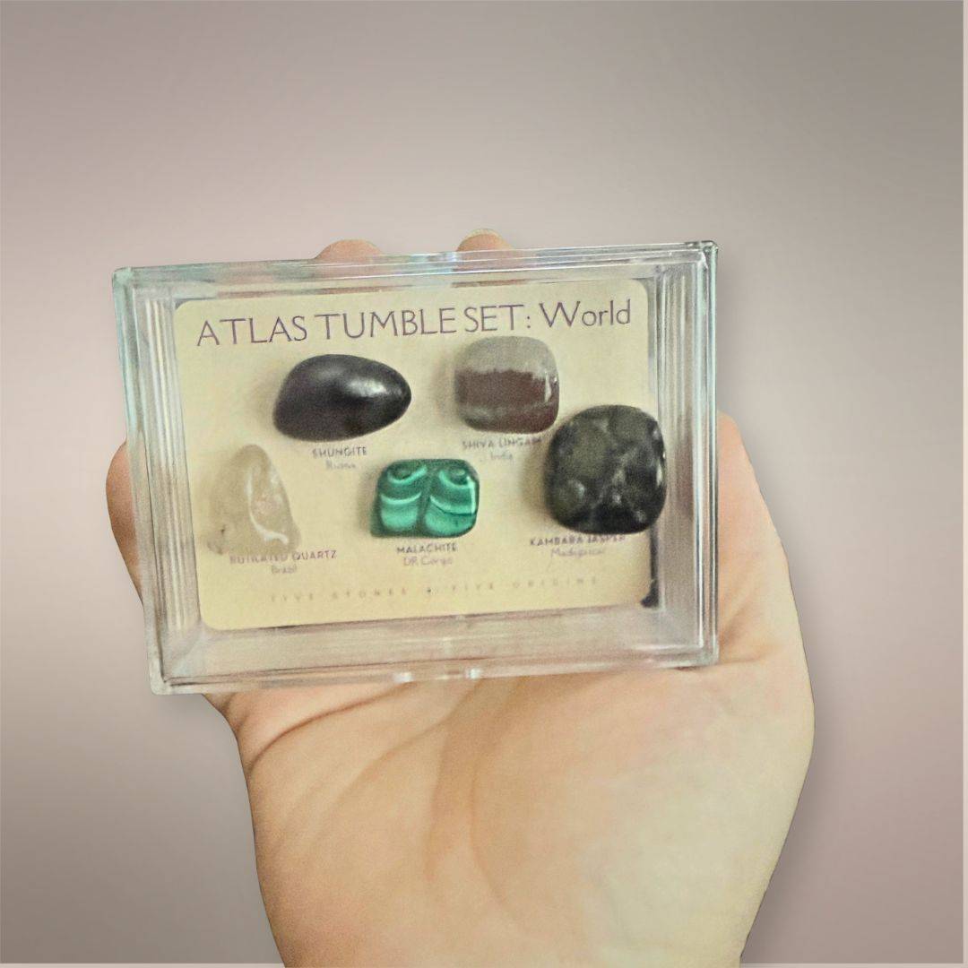 Atlas Tumble Set World acrylic collector case held in hand to show the compact 3.5 by 2.5 inch size