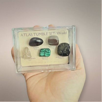 Atlas Tumble Set World acrylic collector case held in hand to show the compact 3.5 by 2.5 inch size