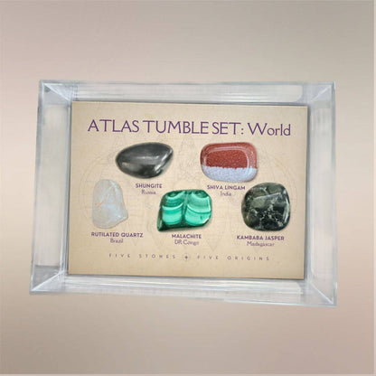 Atlas Tumble Set World displayed in a clear acrylic collector case with five removable tumbled stones from five global origins