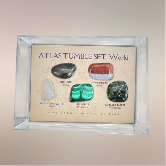 Atlas Tumble Set World displayed in a clear acrylic collector case with five removable tumbled stones from five global origins