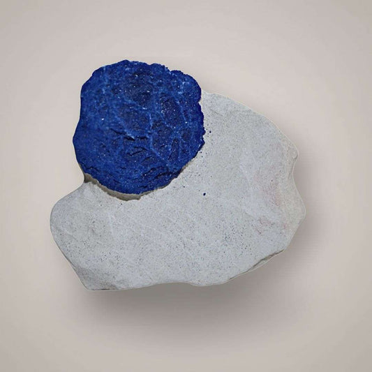 Single Azurite Sun specimen from Malbunka Copper Mine, Australia, with one vivid blue radial disc on pale kaolinite matrix.