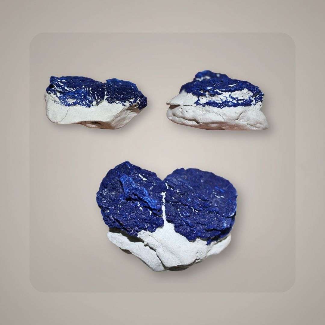 Side view of two gemmy Azurite Suns showing thick blue radial growth and pale matrix.