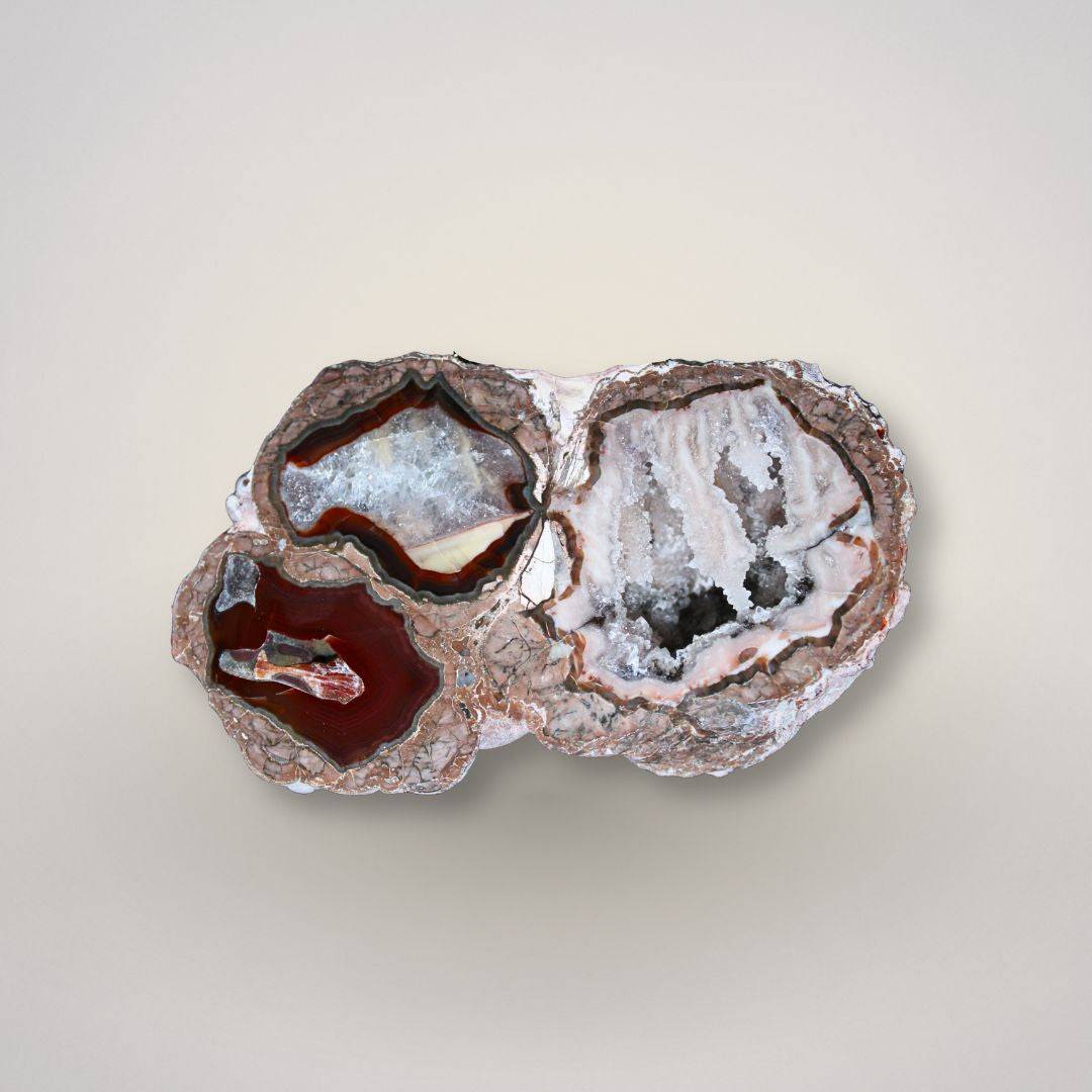 Polished face of Baker Agate thunderegg half with three distinct agate sections, cinnamon druzy, and waterline banding.
