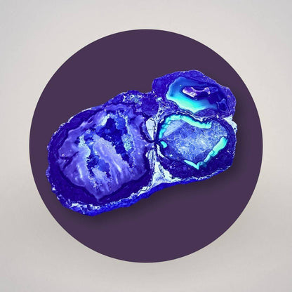Baker Agate thunderegg half under long-wave UV light showing fluorescent response in the agate chambers.