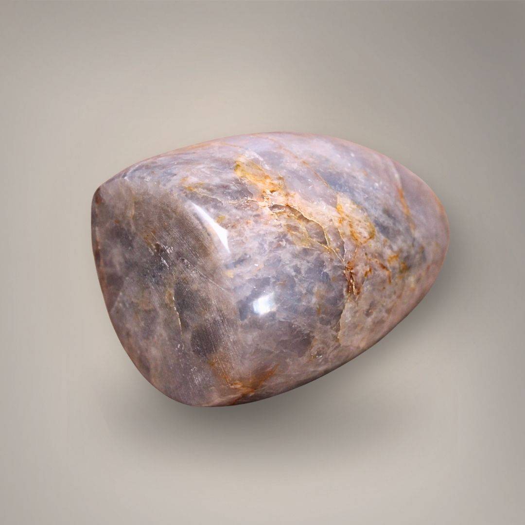 Polished Blue Rose Quartz freeform from Madagascar with lavender-gray marbling and golden-ochre veining.