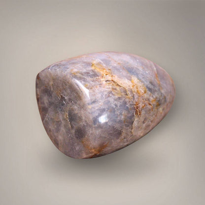 Polished Blue Rose Quartz freeform from Madagascar with lavender-gray marbling and golden-ochre veining.