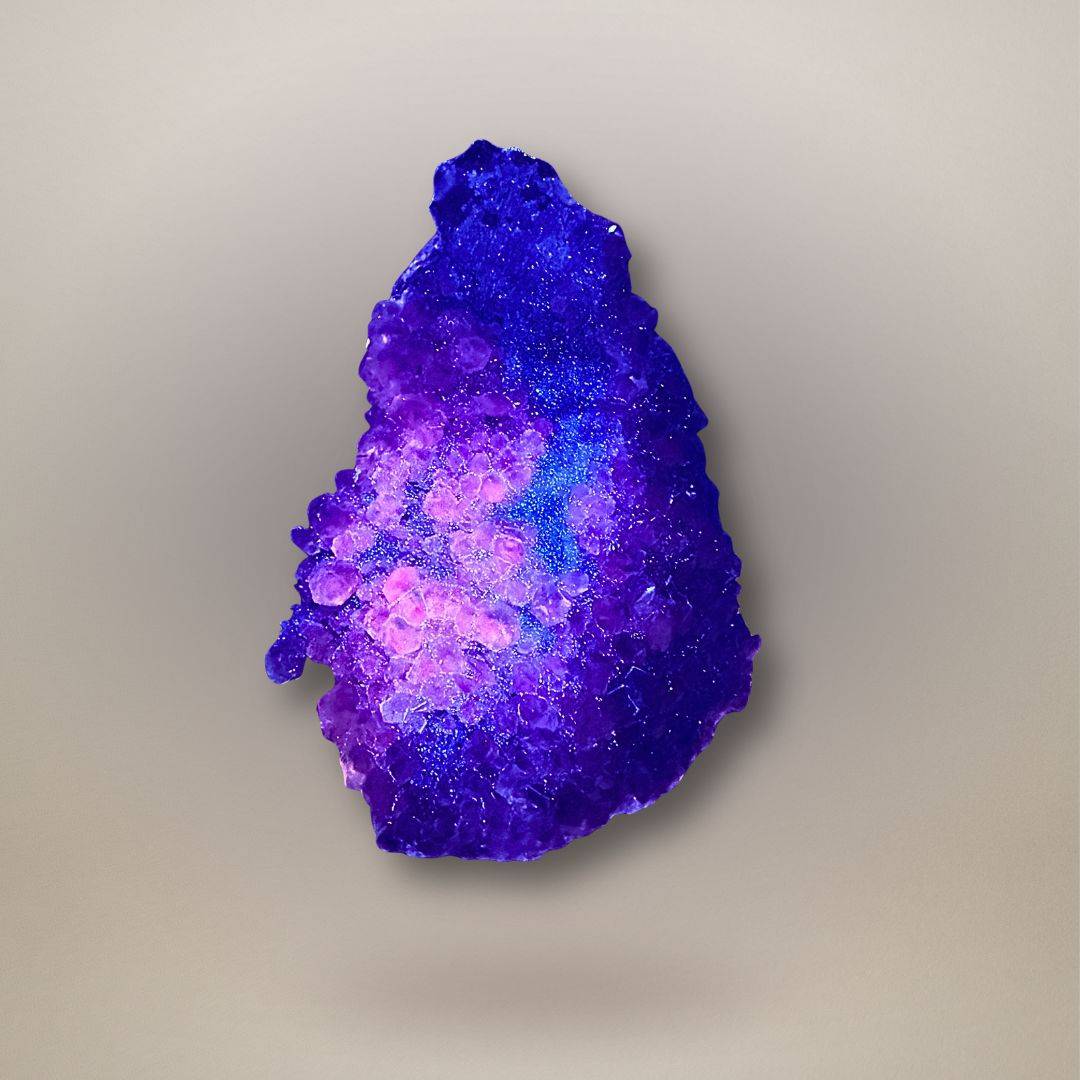 Apophyllite with calcite from Maharashtra, India under UV light, showing vivid pink-orange fluorescence concentrated in the calcite growth.