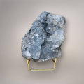Celestine geode cluster on gold stand