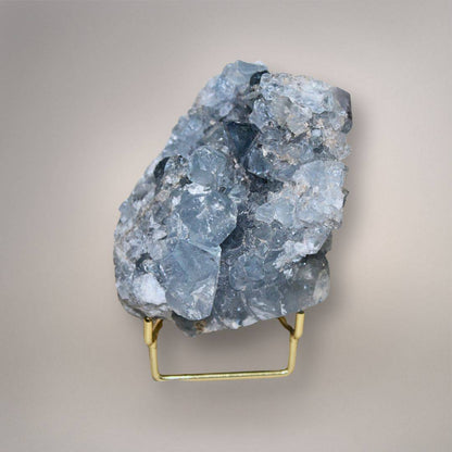Celestine geode cluster on gold stand