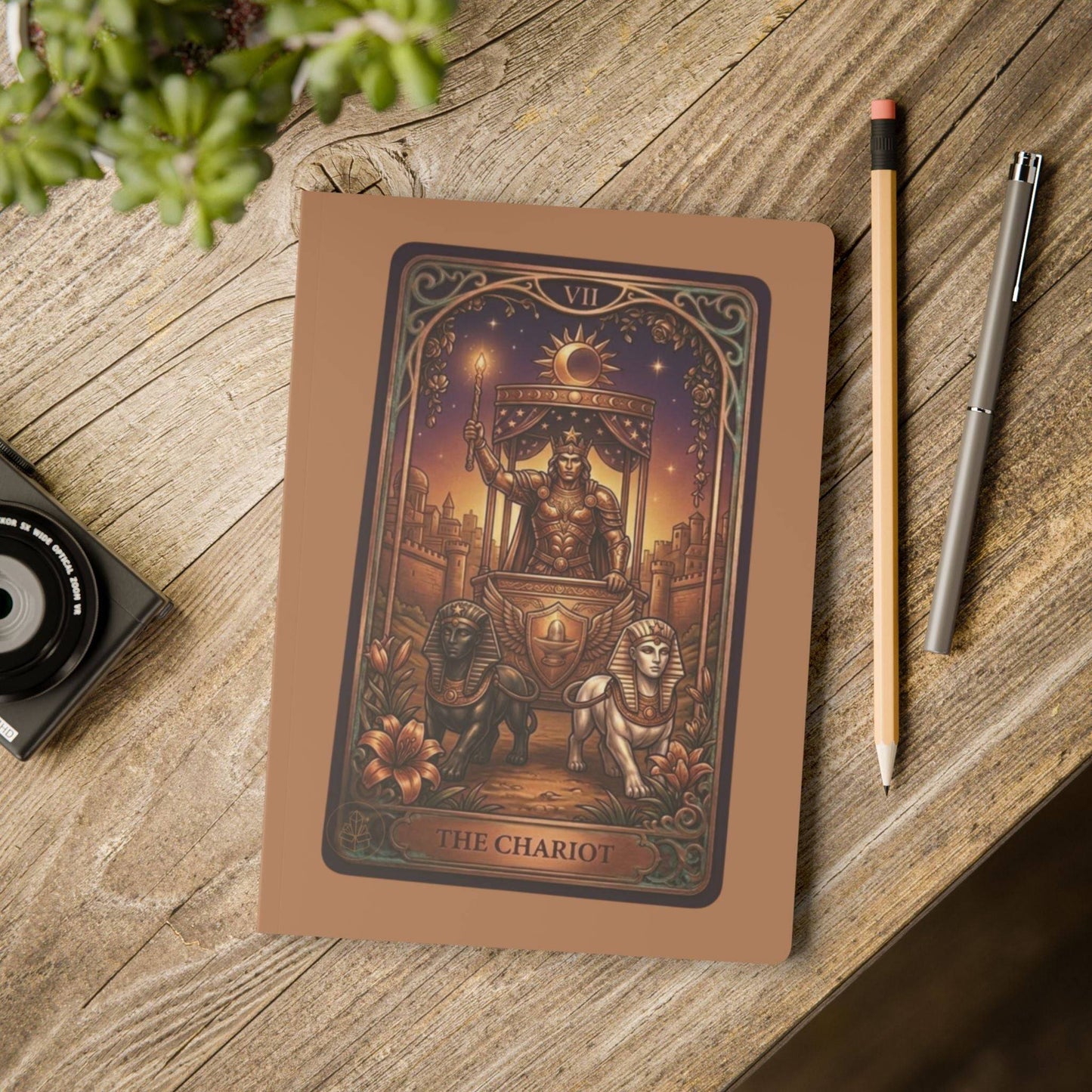The Chariot tarot card on brown notebook cover with celestial design