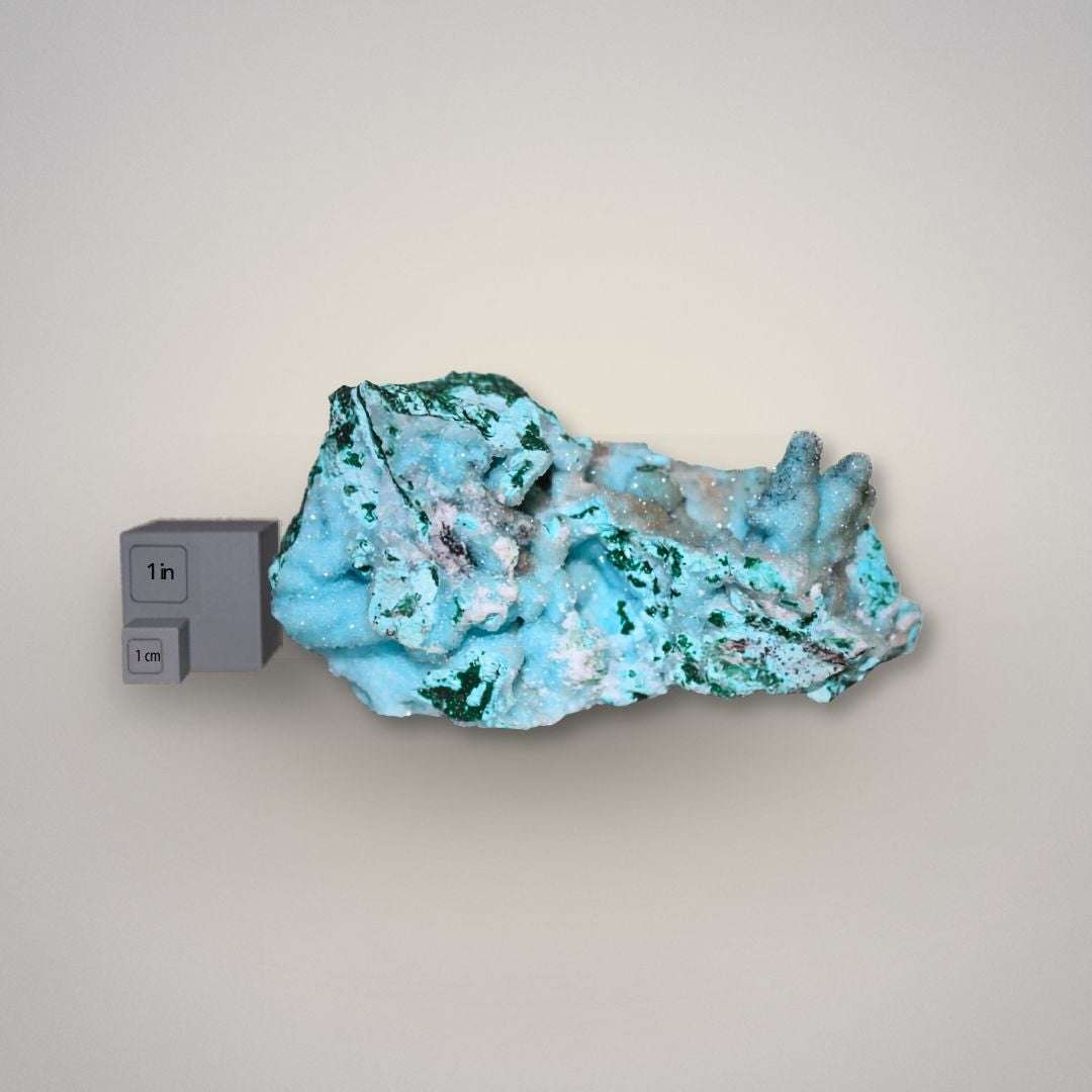 Side view of Chrysocolla and Malachite mineral specimen with scale for size reference