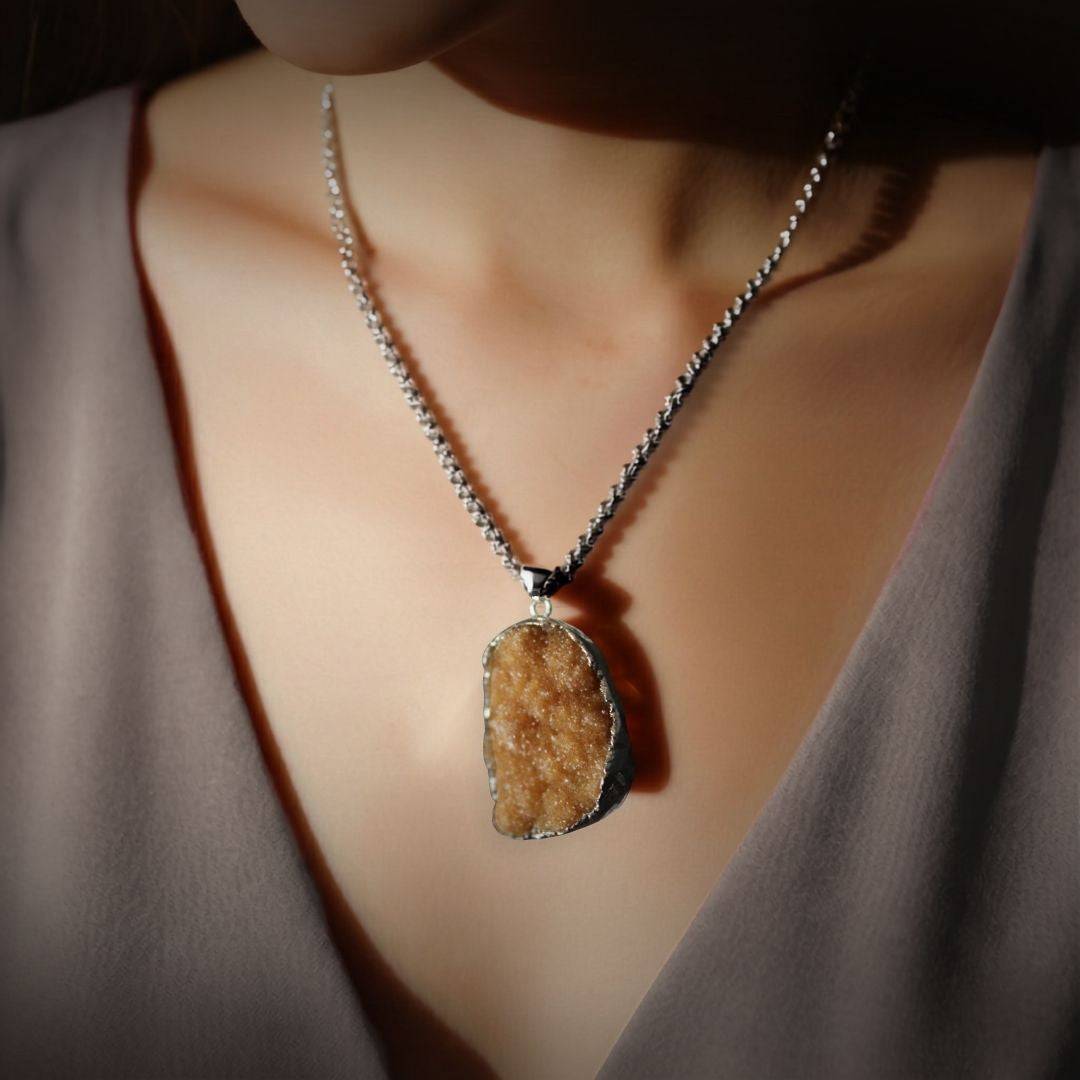 Citrine drusy pendant worn as a necklace in lifestyle image, chain shown for styling only 