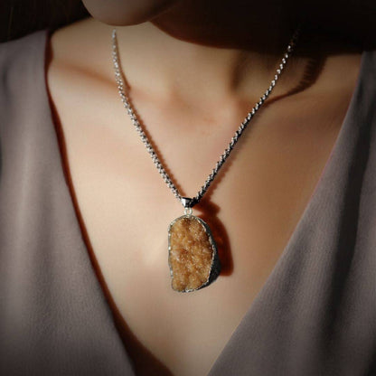 Citrine drusy pendant worn as a necklace in lifestyle image, chain shown for styling only 