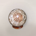 Clear quartz orgonite sphere with Himalayan quartz chips, copper spiral, and wood display stand