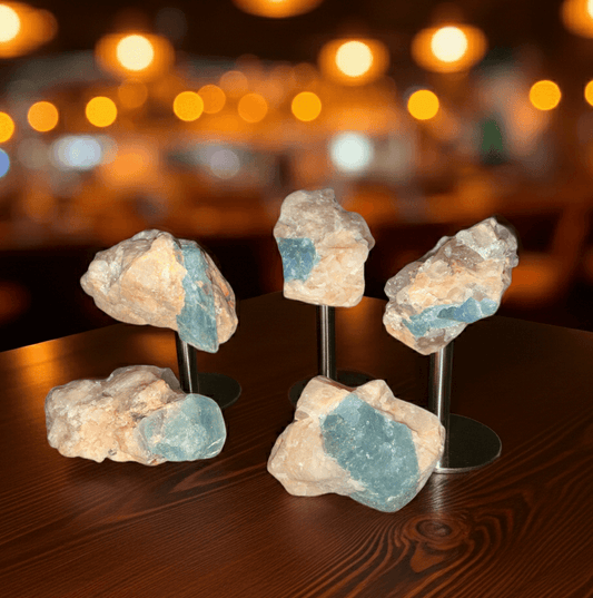 Brazil Gem Trio featuring raw Aquamarine, Peach Moonstone, and Pink Tourmaline specimens on display stands, ideal for gemstone collectors.