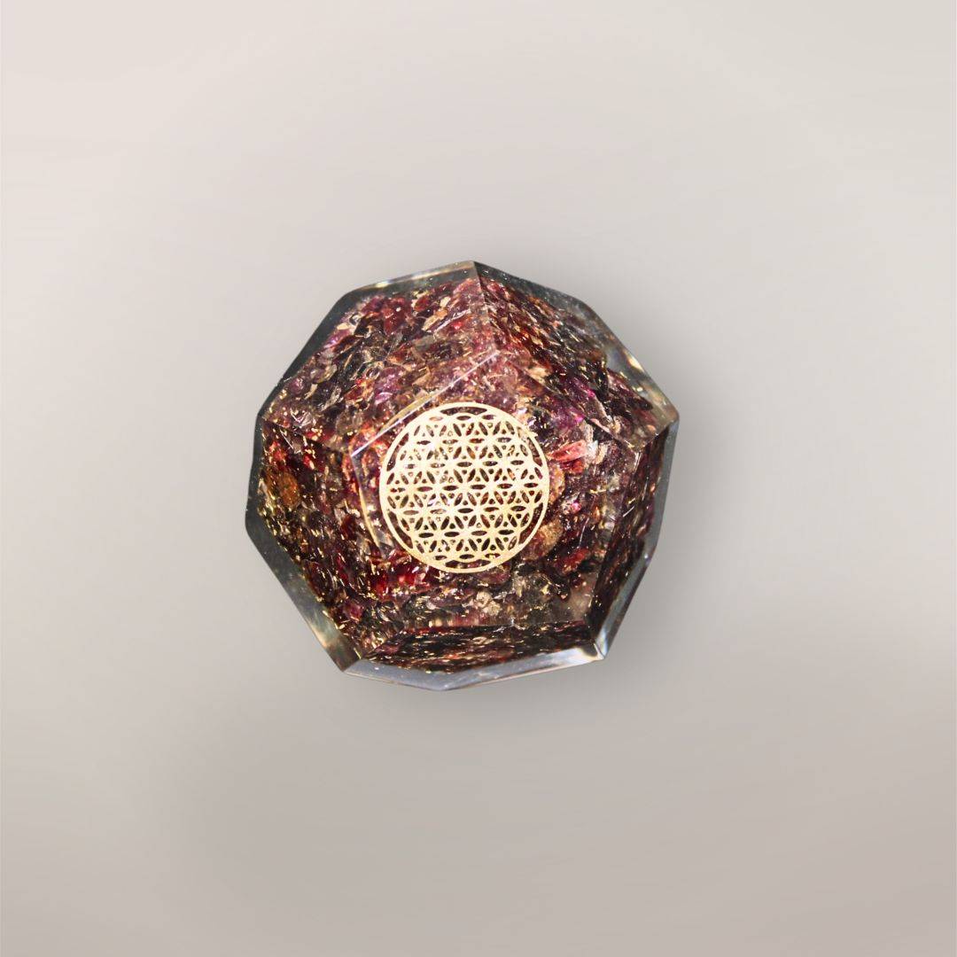 Garnet orgonite dodecahedron with Sri Lankan Garnet chips, golden Flower of Life symbol, metallic flakes, and faceted resin shape