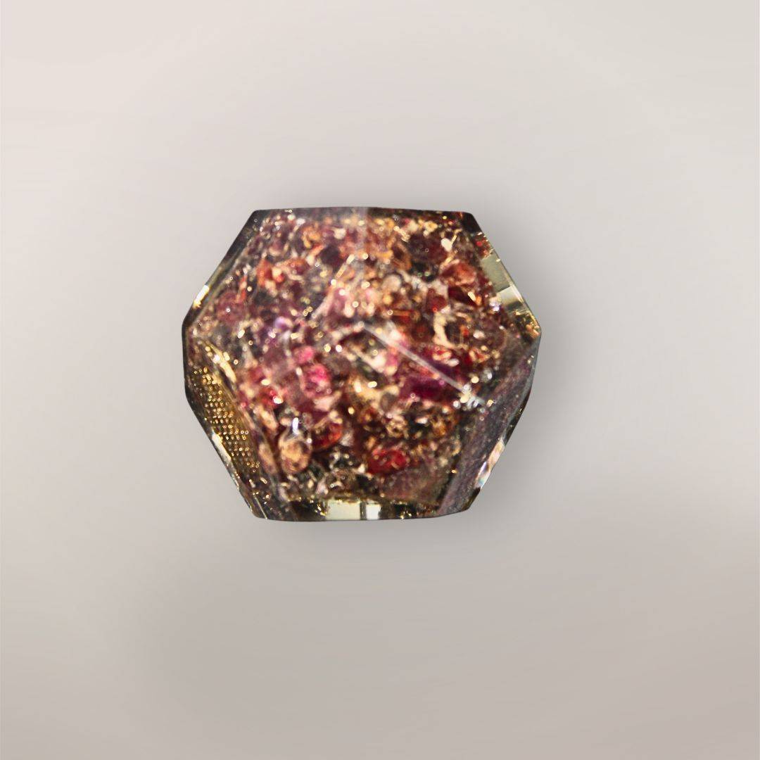 Back view of handmade Garnet orgonite dodecahedron showing deep red crystal chips, metallic flakes, and faceted resin texture