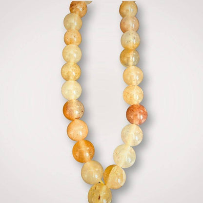 Golden Healer Mala - Energetic Renewal | Handcrafted, Quartz close-up of golden quartz beads showcasing natural variations and polished finish for energy restoration.