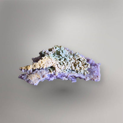 Reverse of 115g Indonesian Grape Agate cluster showing cream and blue-green clay-rich matrix with lavender quartz along the edges