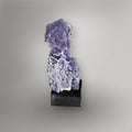 Front view of 183g lavender Grape Agate cluster from Indonesia mounted vertically on a black display base