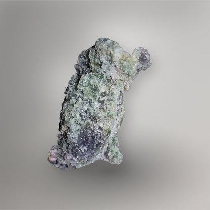 Reverse of 259g Indonesian Grape Agate cluster showing green clay-rich matrix beneath a fine sparkling quartz coating