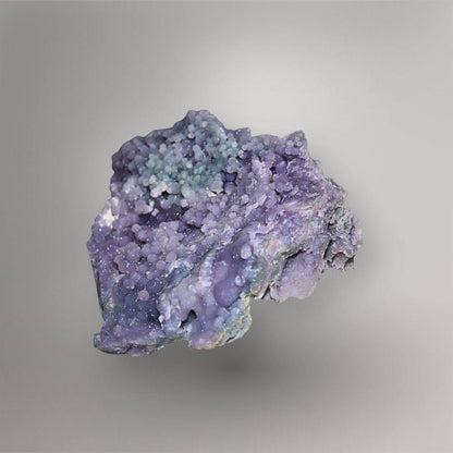 Opposite side of 335g Grape Agate cluster showing purple botryoidal quartz, smooth pocket surfaces, and blue-green accents