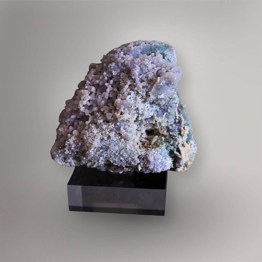 Front view of 437g Grape Agate cluster with pale lavender spheres, blue-green zones, drusy surfaces, and a triangular profile