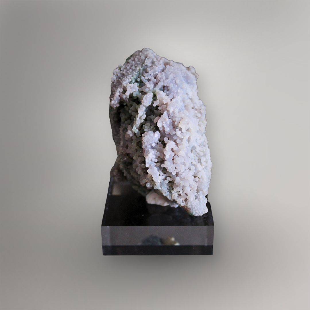 Side view of 437g Grape Agate cluster showing pale lavender botryoidal growth, open spaces, and a narrow layered profile