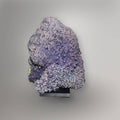 Front view of 770g lavender Grape Agate cluster from Indonesia mounted on a black display base