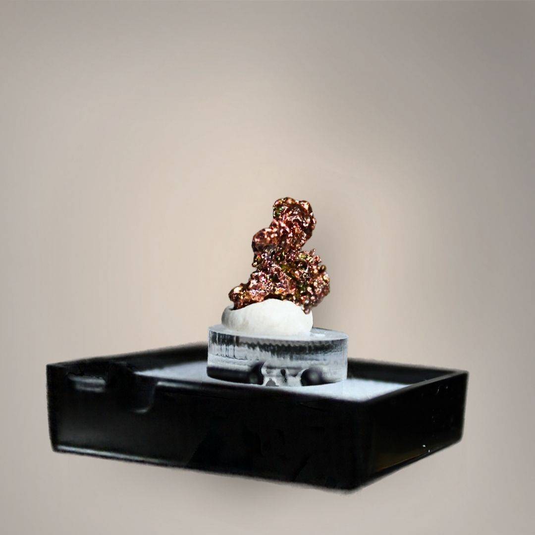 Reverse view of native copper thumbnail from China showing compact, irregular crystalline growth with reflective copper-red, bronze, and golden metallic surfaces on a small acrylic riser.