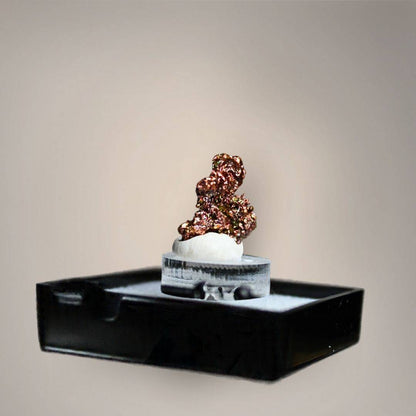 Reverse view of native copper thumbnail from China showing compact, irregular crystalline growth with reflective copper-red, bronze, and golden metallic surfaces on a small acrylic riser.