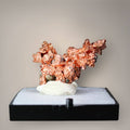 Native copper specimen from China with compact branching growth, angular metallic projections, and copper-red crystalline surfaces displayed on a black perky base.