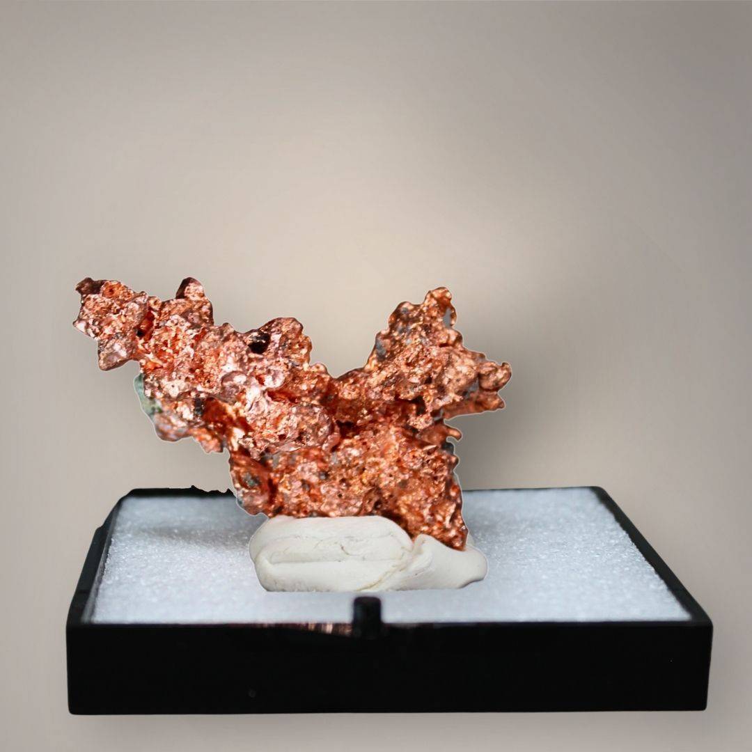 Reverse view of Chinese native copper showing a broad, irregular branching formation, textured metallic surfaces, and darker mineral areas near the base.