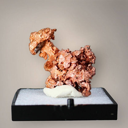 Native copper specimen from China featuring clustered copper-red crystalline growth, irregular branching projections, and textured metallic surfaces displayed on a black perky base.