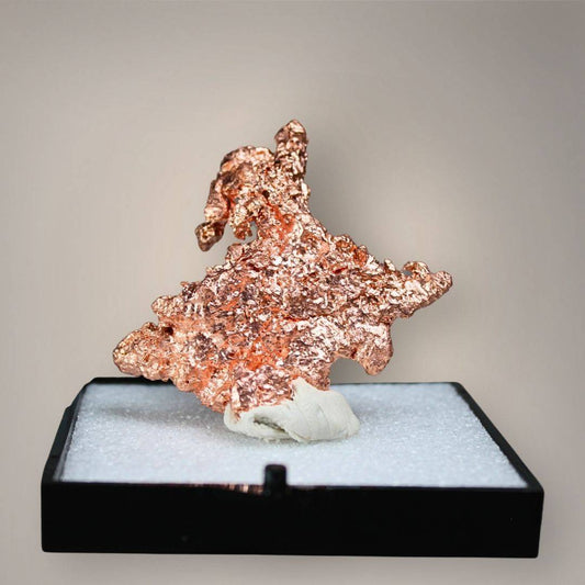 Native copper specimen from China with copper-red metallic luster, irregular branching projections, and textured crystalline growth displayed in a black perky box.