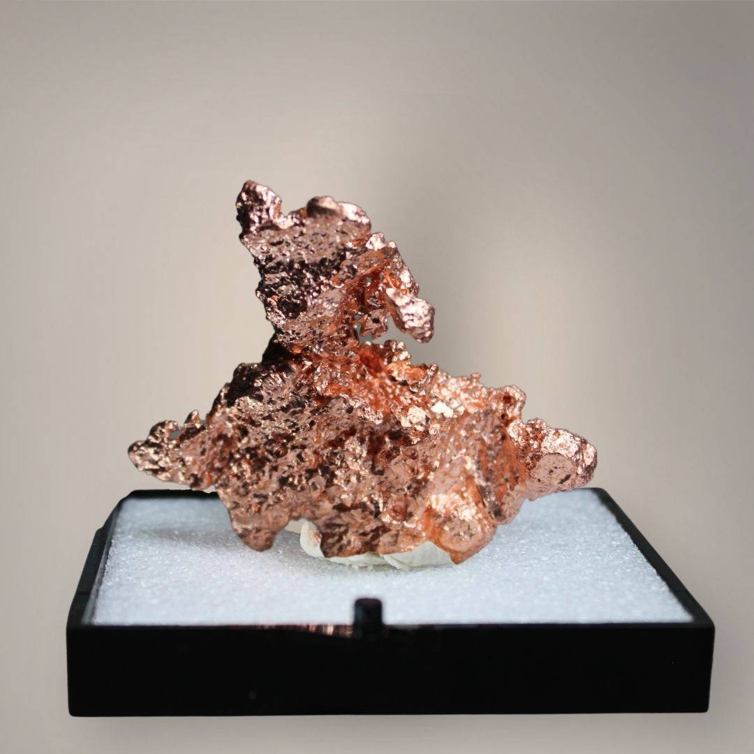 Reverse of Chinese native copper specimen showing darker metallic surfaces, copper-red branching structures, and irregular protruding growths.