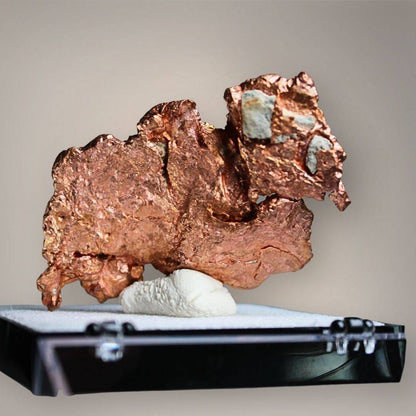 Reverse of Chinese native copper showing broad, flattened metallic surfaces, reddish-brown textures, irregular projections, and small gray-green mineral patches.
