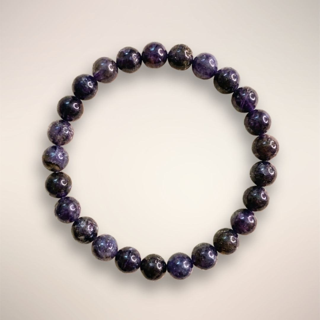 Iolite Beaded Bracelet 8mm displayed on a clear round stand