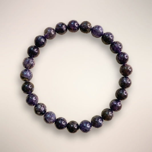 Iolite Beaded Bracelet 8mm displayed on a clear round stand