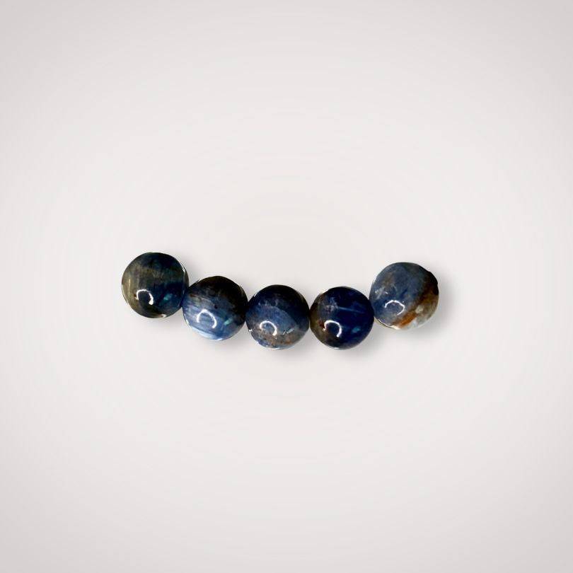 Close-up of five 6mm Blue Kyanite beads highlighting their natural blue hues, perfect for jewelry promoting clarity and calm focus.